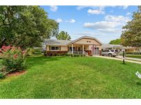 Charming single-story home with a well-maintained lawn, inviting front porch, and attached garage at 8677 Sw 95Th Ln # A, Ocala, FL 34481