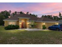 Charming single-story home with a well-maintained lawn and a two-car garage, with updated landscaping at 9562 Sw 45Th Ave, Ocala, FL 34476