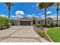 Charming single-story home featuring a well-manicured lawn, lush landscaping, and a spacious driveway at 1443 Sw 161St St, Ocala, FL 34473