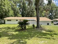 Charming one-story home with a well-maintained lawn and decorative cinder block privacy wall at 1523 Se 80Th St, Ocala, FL 34480
