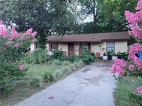 Charming single-story home featuring a well-maintained yard and colorful landscaping at 2312 Ne 37Th St, Ocala, FL 34479