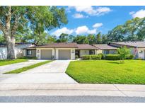 Charming single-story home featuring an attached garage and well-manicured lawn at 3707 Ne 17Th St, Ocala, FL 34470