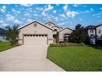 Well-maintained one-story home with a two-car garage, manicured lawn and beautiful landscaping at 3948 Se 4Th Ter, Ocala, FL 34480