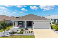 Charming single-story home featuring a well-manicured lawn and a two-car garage at 8913 Sw 76Th Ln, Ocala, FL 34481