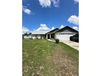Charming single-story home featuring a well-manicured lawn and an attached two-car garage at 13506 Sw 43Rd Cir, Ocala, FL 34473