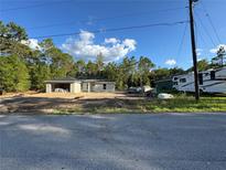 New construction home featuring concrete block walls and a concrete roof, set against a blue sky with white clouds at 19990 Sw 75Th St, Dunnellon, FL 34431