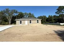 Charming single-story home with a well-maintained lawn and a paved driveway at 2350 Sw 150Th Ct, Ocala, FL 34481