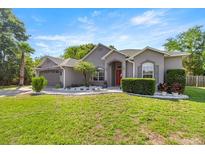 Charming single-story home with lush lawn and mature landscaping, perfect for curb appeal at 2418 Se 22Nd Pl, Ocala, FL 34471