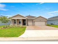 Charming single-story home featuring a well-manicured lawn and a two-car garage at 4474 Nw 53Rd Ave Rd, Ocala, FL 34480