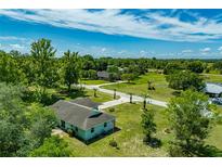 An aerial view of the property showcasing the house, yard, and surrounding landscape at 6773 Se 87Th St, Ocala, FL 34472
