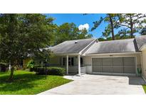 Charming single story home with a well-maintained lawn, attached garage, and welcoming front entrance at 8655 Sw 98Th Street Rd # G, Ocala, FL 34481