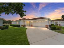 Charming single-story home with a well-manicured lawn and a spacious driveway at 8689 Se 141St Street Rd, Summerfield, FL 34491