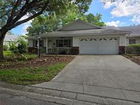 Charming single Gathering home with a two-car garage, front porch, and well-maintained landscaping at 8959 Sw 96Th Ln # A, Ocala, FL 34481