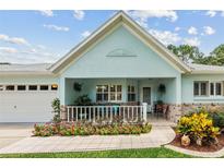 Charming home featuring a cozy front porch with beautiful landscaping and a well-maintained front yard at 8961 Sw 96Th Ln # C, Ocala, FL 34481