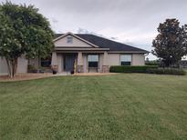 Charming home featuring a lush green lawn and manicured landscaping and craftsman architectural details at 1829 Nw 85Th Loop, Ocala, FL 34475