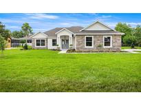 Charming single-story home with stone accents and a lush green lawn at 2792 Se 29Th St, Ocala, FL 34471