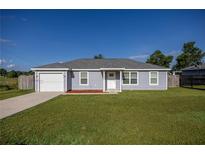 Charming one-story home with a well-manicured lawn and a single-car garage at 3645 Sw 151St Ct, Ocala, FL 34481