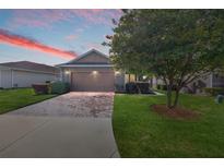 Charming single-story home with a brick-paved driveway and well-maintained lawn at 4970 Nw 35Th Lane Rd, Ocala, FL 34482