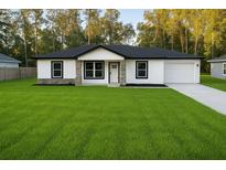 Charming single-story home with a well-manicured lawn and neutral-tone exterior at 5 Laurel Pass Ln, Ocala, FL 34472