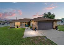 Charming single-story home with stone accents, well-maintained lawn, and inviting curb appeal at 501 Marion Oaks Dr, Ocala, FL 34473