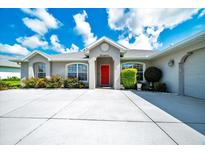 Charming single-story home with a well-manicured lawn and a welcoming red front door at 5459 Sw 86Th St, Ocala, FL 34476