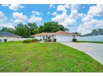Well-maintained lawn and charming landscaping enhance this beautiful home's curb appeal at 6631 Se 11Th Loop, Ocala, FL 34472