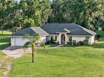 Charming single-story home featuring a well-manicured lawn and inviting front entrance at 6730 Sw 9Th Ave, Ocala, FL 34476