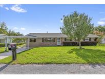 Charming single-story home with a well-manicured lawn, brick accents, and mature tree in the front yard at 713 Se 34Th Ter, Ocala, FL 34471