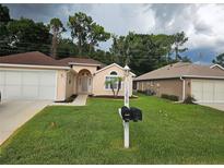 Charming home featuring a well-manicured lawn and lovely curb appeal at 11298 Sw 73Rd Cir, Ocala, FL 34476