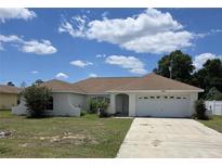 Charming single-story home with an attached garage, a well-maintained lawn and inviting curb appeal at 15084 Sw 28Th Terrace Rd # 3, Ocala, FL 34473