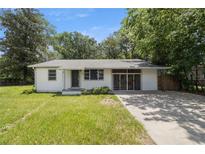 Ranch-style home with a concrete driveway, tidy landscaping, and classic architectural details at 1831 Sw 5Th Ave, Ocala, FL 34471