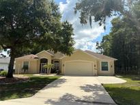 Lovely single-story home with a well-maintained lawn and mature trees in a quiet neighborhood at 19480 Sw 100Th Loop, Dunnellon, FL 34432