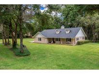 Charming single-story home featuring dormer windows and a well-maintained lawn at 26 Count Fleet Dr, Ocala, FL 34482