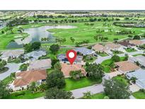 Beautiful home featuring views of a golf course and a serene lake community at 2721 Day Lily Run, The Villages, FL 32162