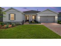 Charming single Gathering home with a well-manicured lawn and neutral exterior paint, accented by decorative stone elements at 4419 Nw 54Th Ter, Ocala, FL 34482