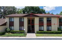Exterior view of a two-story condo with a brown roof and well-maintained landscaping at 505 Fairways Ln # B, Ocala, FL 34472