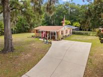 Quaint single-story home with a long driveway and ample space for parking at 581 Ne 44Th Ave, Ocala, FL 34470