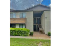 Inviting two-story condo with well-maintained landscaping and exterior stairs to the second floor units at 550 Fairways Dr # A, Ocala, FL 34472