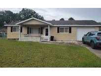 Charming ranch style home with a cozy front porch, one car garage, and well-manicured lawn at 8124 Sw 106Th St, Ocala, FL 34481