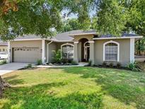 Charming one-story home with a well-maintained lawn and manicured landscaping at 6047 Cason Way, Lakeland, FL 33812