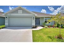Charming single-story home with a well-manicured lawn and a two-car garage in a tranquil neighborhood at 2123 Cartgate Lane, Winter Haven, FL 33884