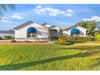 Charming single-story home features a well-manicured lawn and a welcoming front entrance with beautiful awnings at 5660 Sandpipers Dr, Lakeland, FL 33809