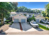Townhouses with attached garages and driveway parking. Lush landscaping at 2310 Isle Royale Se Ct, Winter Haven, FL 33880