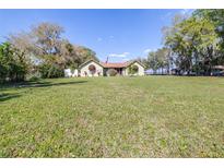Charming single-story home featuring a spacious lawn and inviting curb appeal at 9650 W Lake Marion Rd, Haines City, FL 33844
