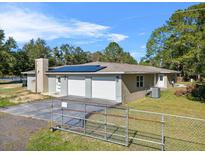 Ranch home with three-car garage and solar panels at 222 Rod Ln, Davenport, FL 33837