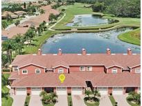 Beautiful aerial view of townhomes near a scenic pond and lush green golf course at 1202 Ashton Palms Dr # 6, Lake Wales, FL 33859