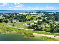 Aerial view of a single-story home with lake access and spacious lot at 405 W 4Th Ct, Frostproof, FL 33843