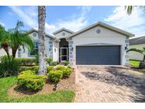 Single-story home with gray garage door and landscaped front yard at 4104 Martindale Loop, Winter Haven, FL 33884