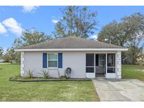 Charming single-story home with blue shutters and a screened front porch entry at 720 S Morrison Ave, Fort Meade, FL 33841