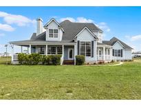 Charming light blue two-story home with a large front lawn and welcoming covered porch at 4071 Albritton Rd, St Cloud, FL 34772